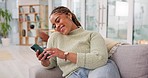 Relax, woman on couch and smartphone with smile, comfortable and cheerful in living room. African American female, lady and cellphone with network signal, social media or connection for communication