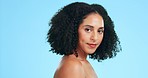 Makeup, skincare and face of black woman for beauty, wellness and facial treatment on blue background. Dermatology, spa aesthetic and confident girl in studio for cosmetics, luxury salon or hair care