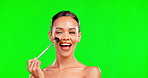 Beauty, face and makeup brush for a woman portrait on green screen background for cosmetics. Aesthetic model person smile and excited for self care tools, skincare and facial shine for spa mockup