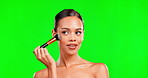 Beauty, makeup brush and woman on green screen background for cosmetics and glow. Aesthetic female model face with smile for skin and facial powder product shine for skincare mockup in studio