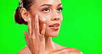 Woman, face and skincare moisturizer on green screen, mockup or chromakey against a studio background. Female beauty model applying lotion, cream or moisturizing product for facial, self love or care