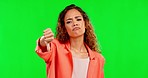 Girl, studio and thumbs down by green screen background with sad face, negative answer or no. Model, woman or portrait in bad review with mock up, hand icon or sign language communication by backdrop