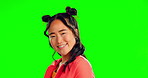 Portrait, wink and an asian woman on a green screen background in studio feeling playful or flirty. Face, smile or silly with a happy and attractive young female posing on chromakey mockup