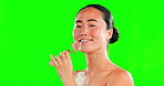 Skincare, beauty and face of Asian woman with roller on green screen in studio isolated on a background. Dermatology cosmetics, portrait and happy female model with rose quartz for skin treatment.