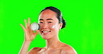 Face, skincare and woman with cream container on green screen in studio on background. Dermatology, cosmetics portrait and happy Asian female model with product, lotion or moisturizer for skin beauty
