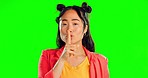 Secret, face and woman with finger on lips in studio, background and privacy sign. Portrait of asian model, silence and shush of quiet, gossip or whisper emoji of confidential mystery on green screen