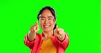 Green screen, face and woman with you hands, thumbs up and happy winner on mockup background. Portrait, emoji and finger pointing by asian girl excited for choice, good news or results in studio