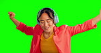 Headphones, dancing and woman face isolated on studio background or green screen listening to music. Asian person singing and dance with audio technology for happy mental health, wellness and energy
