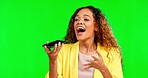 Happy, phone call and woman on green screen in studio, excited and sharing good news, voice to text or message. Speaker, smartphone and girl cheerful, smile and celebrating promotion while isolated