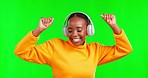 Dance, enjoying and a black woman with music on a green screen isolated on a studio background. Happy, carefree and an African girl listening to radio songs, streaming audio and dancing to a track