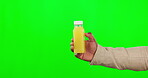 Hand, juice and mockup on a green screen background in studio for health, nutrition or detox for wellness. Bottle, product and diet with a person holding a container for weight loss or vitamins