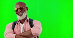 Black man, portrait and smile with sunglasses on green screen with arms crossed and backpack. African senior male model on a studio background with mockup space for fashion, travel and cool attitude