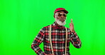 Dance, music and an elderly black man on a green screen background in studio having fun moving with rhythm. Party, fashion and funky with a happy senior man dancing on chromakey mockup for freedom