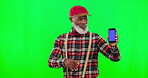 Dancing, phone and senior black man pointing, showing and advertising cellphone screen isolated in a green screen studio background. Excited, funny and portrait of a goofy old person in with mockup