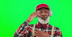 Dance, music and a mature black man with headphones on a green screen background in studio having fun. Party, fashion and funky with a happy senior man dancing on chromakey mockup for freedom