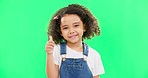 Happy, green screen and face of a child with a thumbs up isolated on a studio background. Winning, success and portrait of a girl kid with an emoji hand gesture for motivation, yes and agreement