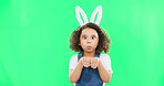 Children, easter and playful with a girl on a green screen background in studio feeling silly while having fun. Kids, bunny and holiday with a cute little female child playing on chromakey mockup