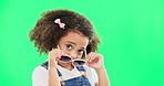 Cute, green screen and girl with sunglasses in studio with sassy, innocent and goofy attitude. Happiness, smile and portrait of child with funky, fashion and stylish glasses by chroma key background.