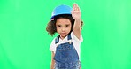Stop, builder and face of a child on green screen isolated on a studio background. Safety, security and portrait of girl kid with a warning hand for building, renovation and construction maintenance