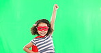 Child, superhero and hand to fly on green screen to stop crime and fight with fantasy or cosplay costume. Girl power, hero and game with smile of strong kid portrait to protect freedom and justice