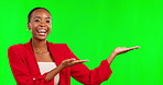 Black woman, showing and green screen for product placement, marketing or advertising against a studio background. Happy African American female pointing advertisement, news or notification on mockup