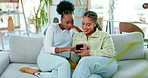 Phone, sofa and friends browsing on social media, the internet or mobile app together at home. Happy, conversation and women scrolling on a cellphone while relaxing in the living room at their house.