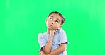 Green screen, thinking and confused child in studio with decision, contemplation and pensive on mockup background. Doubt, emoji and unsure girl contemplating choice, why or solution while isolated