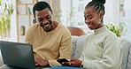 Black couple laugh, tech and home of happy young people looking at funny meme while internet banking. Happiness, smile and digital investing plan of a woman and man together on a living room sofa