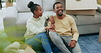 Black couple relax on floor, moving in and conversation while taking break, new home owner and communication. Happy people in living room, relationship with resting and talking in house with planning