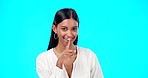 Secret, face and happy woman with finger on lips in studio, blue background or privacy sign. Portrait of indian model, silence and shush of quiet, gossip or whisper emoji of confidential mystery news