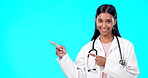Medical doctor, healthcare and happy woman point at mock up promotion, hospital notification or announcement mockup. Nurse portrait, studio advertising surgeon or marketing female on blue background