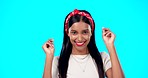 Happy, excited Indian woman and dancing in studio with makeup on blue background, smile, happiness and mockup. Streaming music, dance and happy person with fun at party celebration with green screen.