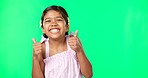 Happy, excited and face of a child with thumbs up on a green screen isolated on a studio background. Success, review and portrait of a girl showing an emoji hand icon for satisfaction and like