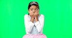 Scared, fear and child with anxiety on green screen with crown, princess costume and tutu in studio. Stress, worry mockup and isolated young girl with worried, sadness and anxious facial expression