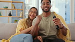 Couple watch sports together, relax and hug, quality time at home, remote control with streaming service. Love, partnership and man cheers for team win with woman on sofa in interracial relationship