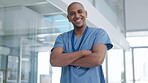 Healthcare, happy and a man nurse in the hospital, standing arms crossed ready for treatment or wellness. Medical, portrait and smile with a confident male medicine professional working in a clinic