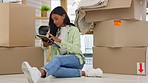 Tablet, boxes and female moving to a house or apartment doing research for her space. Technology, relax and young woman planning her modern home on the internet with a mobile device on the floor.