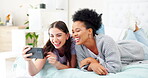 Woman, friends and phone laughing on video call for funny joke, meme or communication on bed at home. Women talking on mobile smartphone with laugh for silly conversation or discussion in bedroom