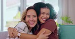 Friends, diversity and women hugging on sofa with smile, happiness and solidarity in love and pride. Lesbian couple, woman and friend in happy embrace for support and trust together in living room.