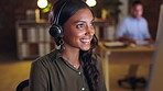 Business woman, call center and consulting at night with headphones on computer in customer service or support. Happy female consultant agent working late talking on PC for online advice at workplace