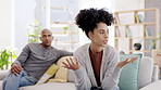 Couple, argument and fighting in disagreement on sofa in living room dispute or unhappy relationship at home. Frustrated woman and man upset in breakup, affair or fight for infertility or conflict