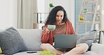 Woman, coffee and laptop on sofa in living room, online shopping and social networking blog at home. Happy female relax on couch, computer and download media, website search and internet subscription