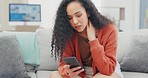 Woman, phone texting and reading on sofa in home lounge with stress, bored or frustrated for communication. Girl, smartphone and social media app on internet, web chat and thinking with annoyed face