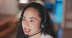 Woman, call center and consulting at night in customer support, telemarketing or service at the office. Happy and friendly female consultant agent working late with headphones and mic for online help