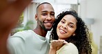 Selfie, happy and portrait of a couple in the living room of their new modern home together. Happiness, smile and young woman blowing a kiss while taking a picture with her husband in their house.