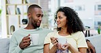 Love, coffee and black couple on couch, happy and conversation in living room, relax and happiness. Romance, man and woman with tea, latte and cappuccino in lounge, sofa and relationship with smile