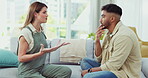 Couple, fighting or arguing about divorce, cheating and infidelity in the living room of their home. Marriage, conflict or breakup with a man and woman having an argument about separation or anger