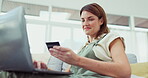 Happy woman, laptop and credit card for online shopping, ecommerce or purchase on living room sofa at home. Female shopper smiling for internet banking, wireless transaction or bank app on couch