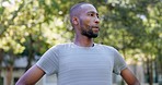 Black man, runner and breathing in park for workout, looking around and peace in nature for mindset. Male, tired and fatigue by trees for exercise, training or relax for wellness, fitness and running