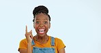 Happy, point and face of excited black woman in studio for happiness, confidence and information. Advertising, emoji mockup and portrait of girl on blue background for good news, omg and announcement